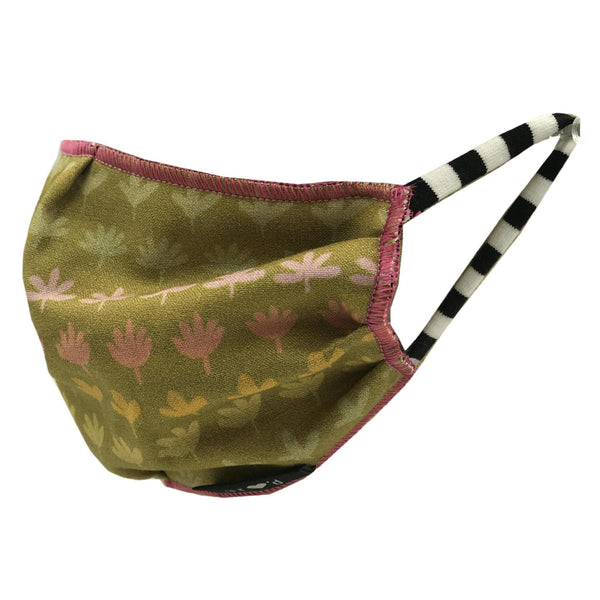 Pleated and lined kids face mask with a print of various shades of pink, yellow and green flowers in horizontal rows on a green background, with black and white striped stretch cotton ear loops. Hand-sewn in the USA, sustainably made in eco-conscious fair labor facilities with upcycled materials.